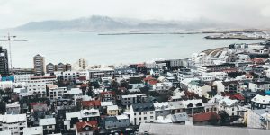 aerial view of city buildings near body of water during daytime