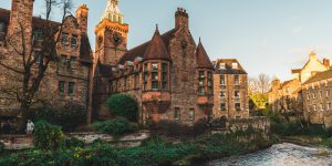 brown concrete building near river during daytime